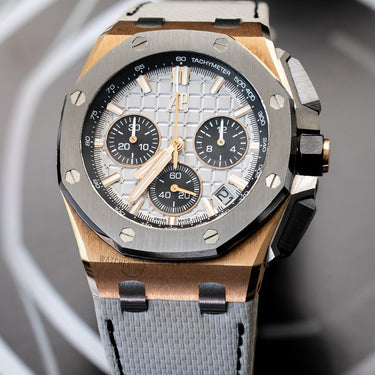 Gold Royal Oak Offshore with cream grey colored strap and dial, black bezel. Shown photographed over a dark background.